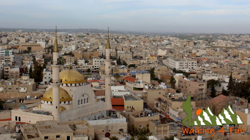 A view overlooking the city of Madaba with a large, prominent mosque towering over the rest of the city