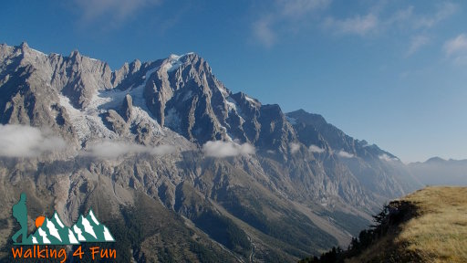 Dramatic glacier-carved mountains with active glaciers towering thousands of feet high